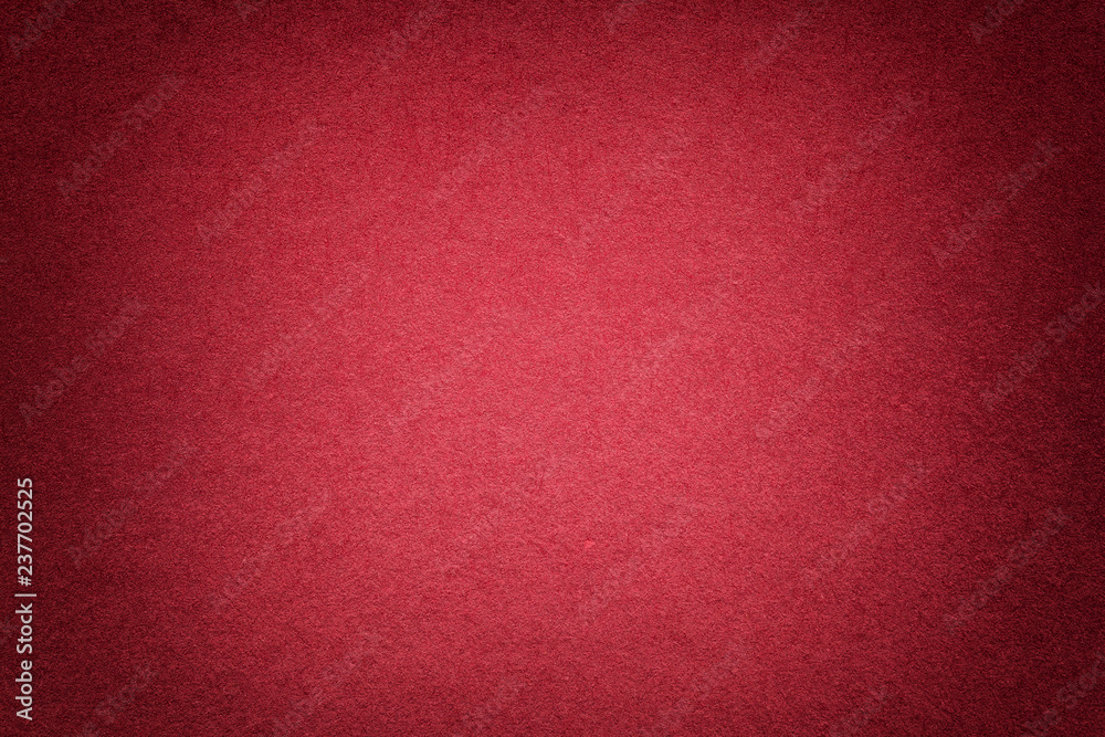 Fototapeta premium Texture of old bright red paper background, closeup. Structure of dense cardboard.