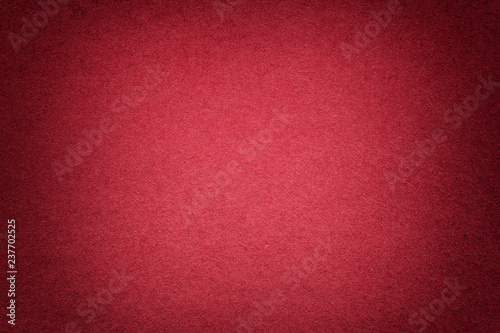 Texture of old bright red paper background, closeup. Structure of dense cardboard. © nikol85