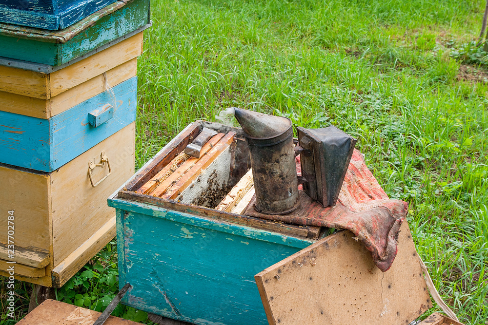 Old smoker on open beehive body .. Old smoker on open beehive body ..