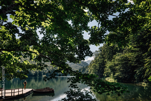 turist stay on male near lake in forest