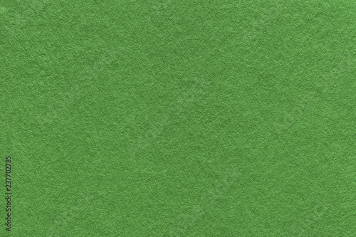 Texture of old dark green paper background, closeup. Structure of dense moss cardboard