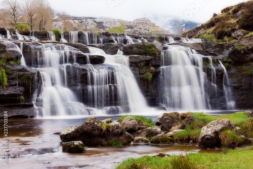 Silky waterfall on the mountain with dramatic ambience photo