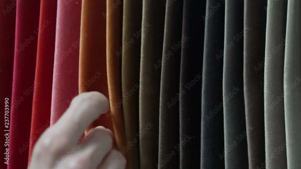 Interior designer selects fabric samples. Designer at work. Architect desk. Decoration. Decorative material. Flatlay. Woman chooses the color of designer velvet in shades of orange
