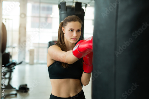 beautiful young girl engaged in training boxing gym © Alexandr