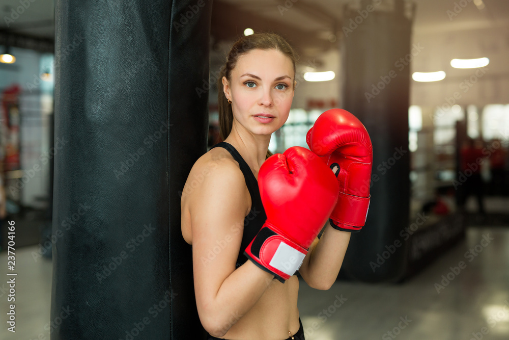 beautiful young girl training in a boxing gym