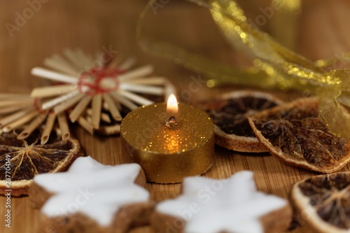 Golden candle with Christmas cookies and decoration