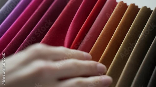 Interior designer selects fabric samples. Designer at work. Architect desk. Decoration. Decorative material. Flatlay. Woman chooses the color of designer velvet in shades of brown photo