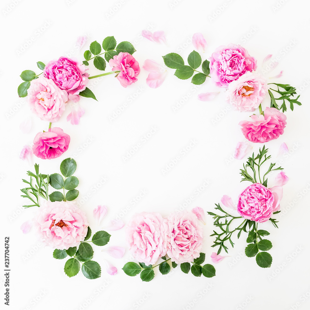Floral wreath frame made of pink roses and peonies with green leaves on white background. Flat lay, top view. Flower background