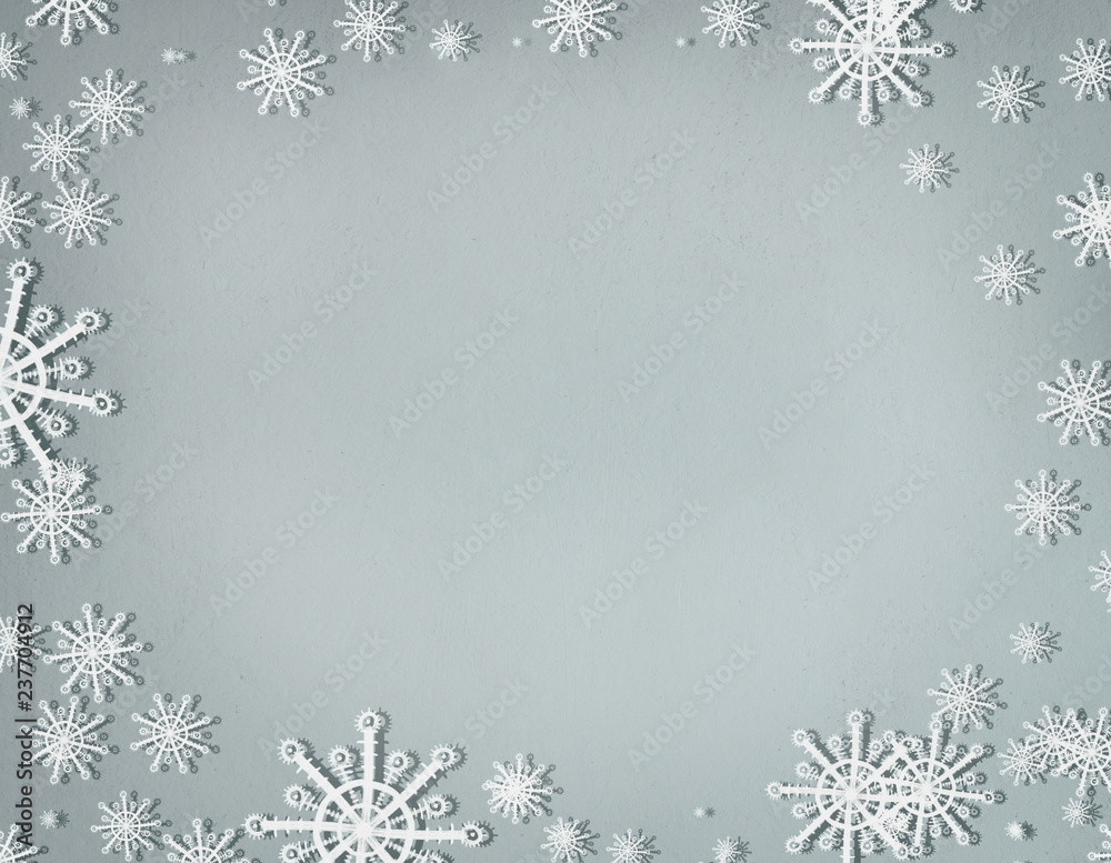 Snowflakes frame on cold gray background with copy space, top view. Christmas and winter holiday concept