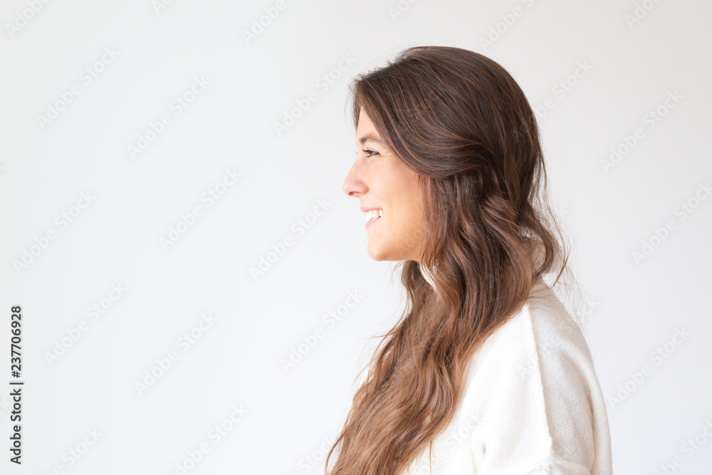 Beautiful smiling Hispanic girl with long hair, side view. Profile portrait of attractive Latin woman smiling and looking aside. Isolated on white. Beauty concept Beautiful smiling Hispanic girl with long hair, side view. Profile portrait of attractive Latin woman smiling and looking aside. Isolated on white. Beauty concept