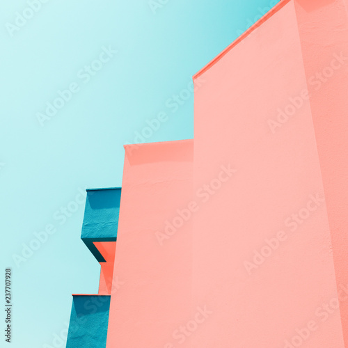 Abstract background with modern building toned in trendy colors of the year 2019. Living Coral and Limpet Shell.
