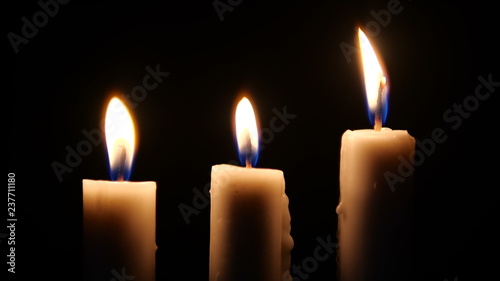 Footage of candles are lit in the darkness. Christmas photo