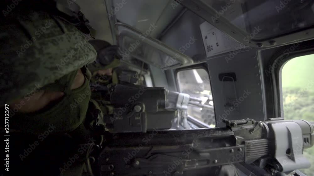 Russian special forces soldiers fly in a combat helicopter MI-35m (Hind).