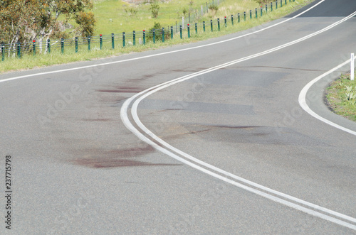 Large blood stain on rural road after wildlife roadkill
