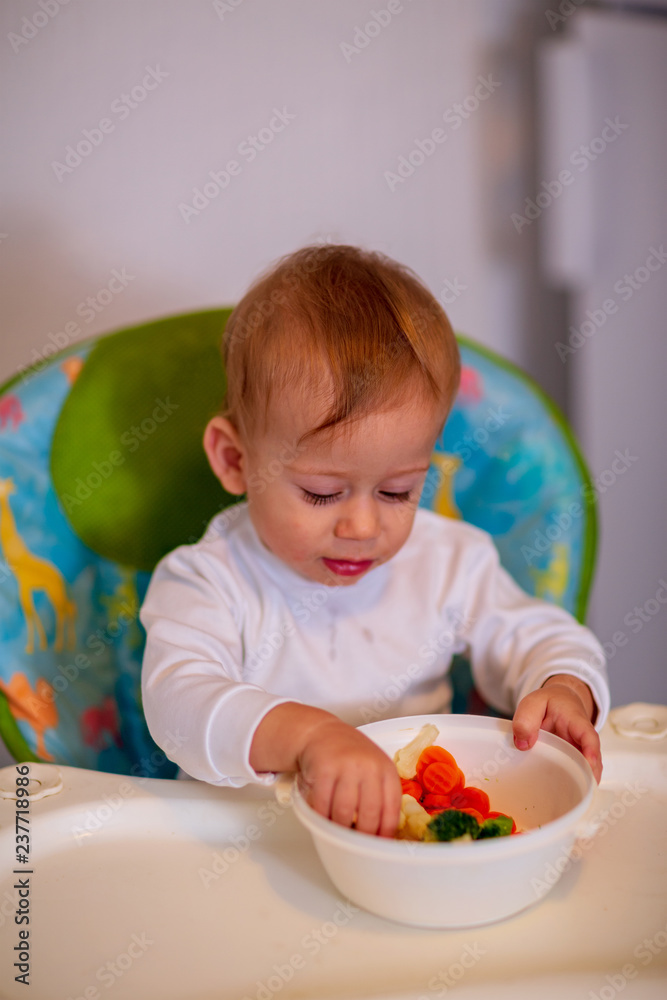 boy eating healthy vegetables at kitchen. boy eating healthy vegetables at kitchen.