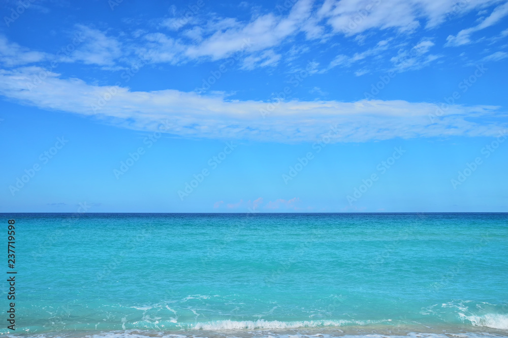 line of the ocean, small waves, horizon, endless distance, against the sky covered with clouds