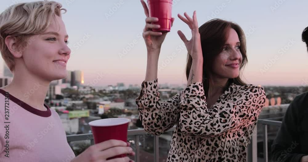 Group of friends dancing at a rooftop party
