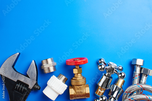 Fotografija plumbing tools and equipment on blue background with copy space