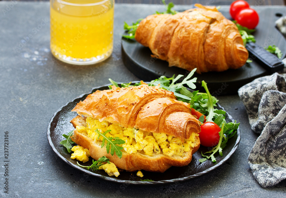 Breakfast of croissant with scrambled eggs and salad. Breakfast of croissant with scrambled eggs and salad.