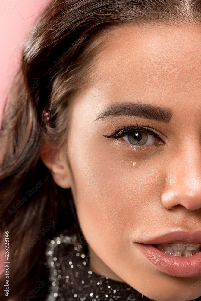 Beautiful young woman with teeth braces on pink. half face of pretty girl Beautiful young woman with teeth braces on pink. half face of pretty girl