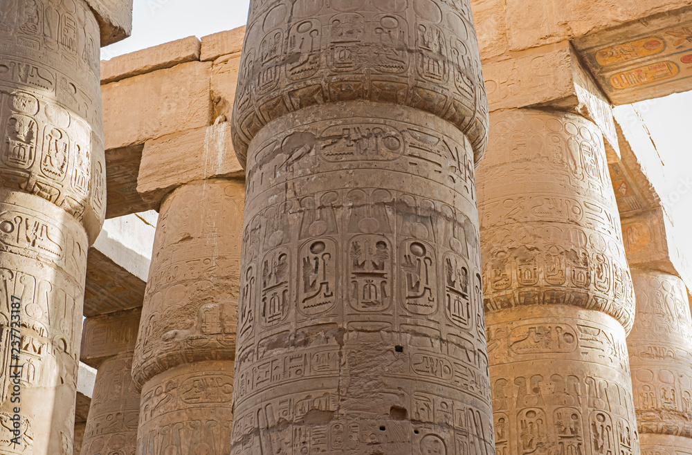 Ancient egyptian hieroglyphic carvings on columns in temple Ancient egyptian hieroglyphic carvings on columns in temple