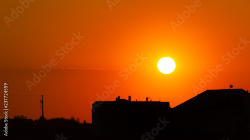 Colorful sunset with the silhouettes of two buildings