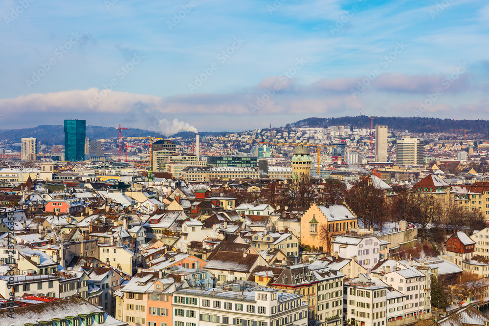 The city of Zurich in Switzerland as seen from the tower of the Grossmunster cathedral in winter. Zurich is the largest city in Switzerland and the capital of the Swiss canton of Zurich.