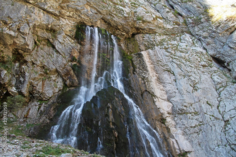 Gegsky waterfall flowing from the cliff in the Caucasus mountains on an autumn day, Abkhazia. Gegsky waterfall flowing from the cliff in the Caucasus mountains on an autumn day, Abkhazia.