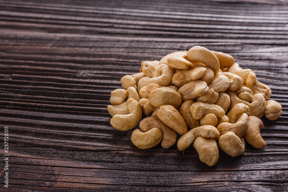 cashew nuts on a rustic wooden background cashew nuts on a rustic wooden background