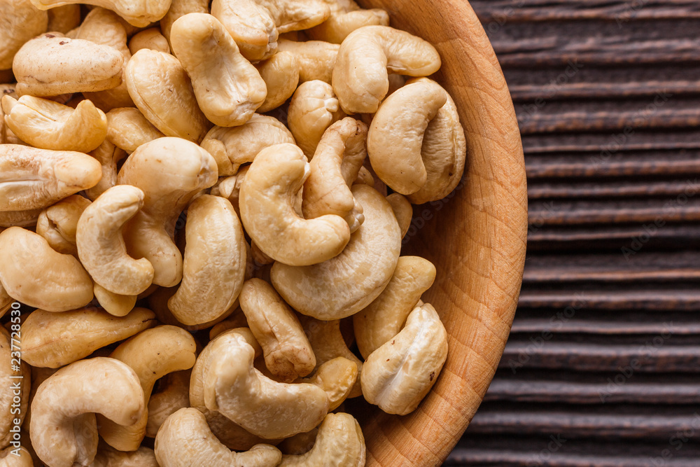 Fototapeta premium cashew nuts on a rustic wooden background