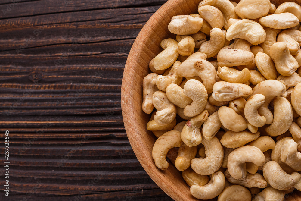 cashew nuts on a rustic wooden background cashew nuts on a rustic wooden background