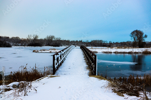 Bridge over frozen lake in winter © Brian