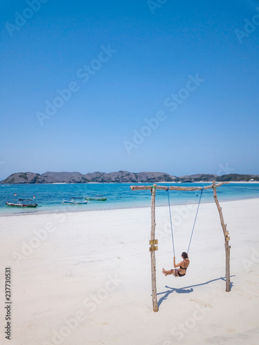 Indonesia, Lombok, young woman on a swing