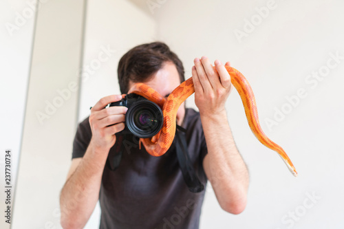 Snake slithering around camera of a man photo