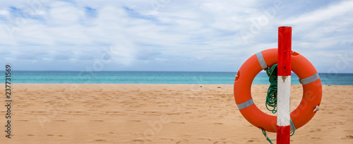 Life preserver on sandy beach, Life belt on the beach 