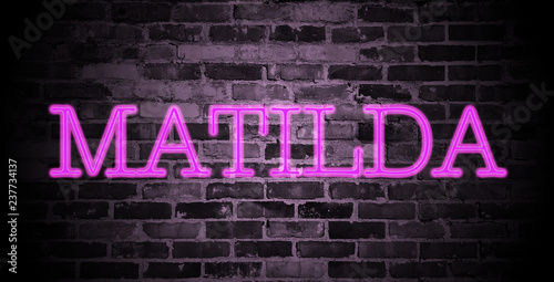 first name Matilda in pink neon on brick wall