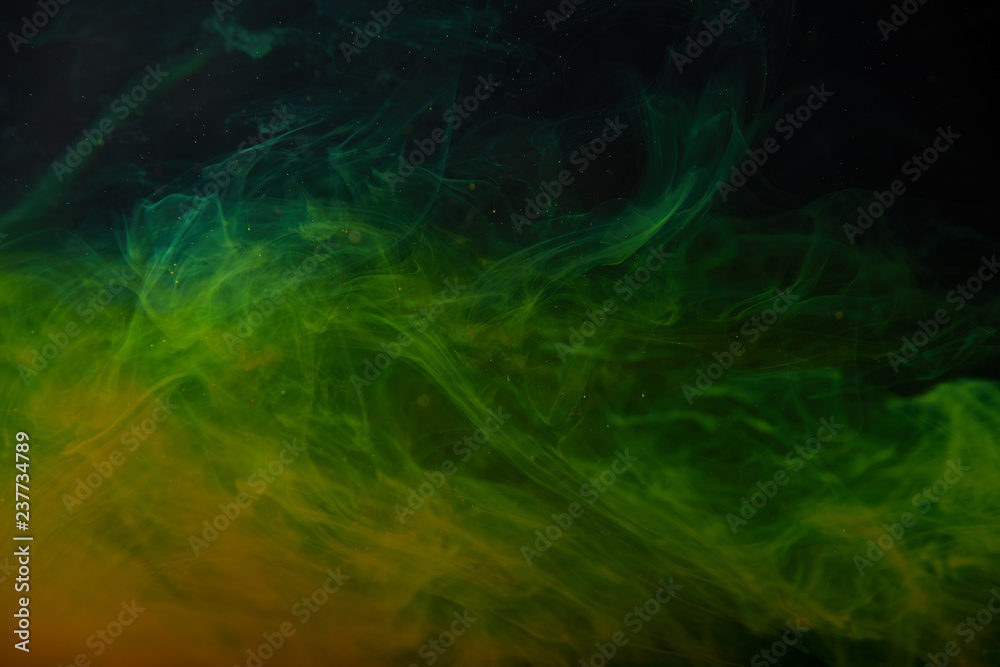 abstract texture with green and orange swirls of paint