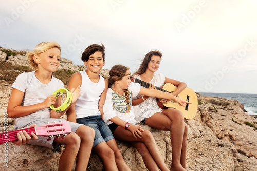 Group of young musicians having fun on the beach © Sergey Novikov