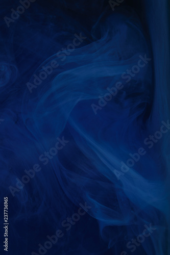 abstract dark texture with blue swirls of paint