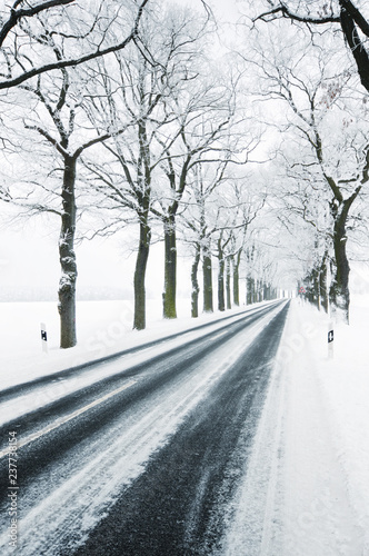 road covered with snow. car track.