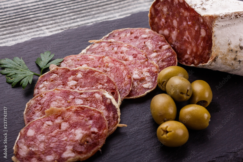Saucisson sec delicious french salami on a wooden background Saucisson sec delicious french salami on a wooden background