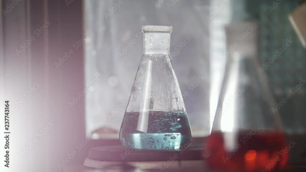 The glass flasks heat up in medical laboratory The glass flasks heat up in medical laboratory