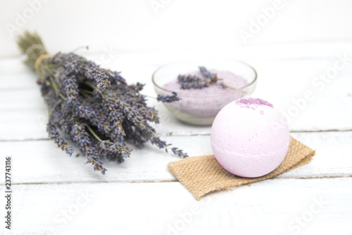 Natural cosmetics. Handmade lavender bath bombs and lavender flowers on white wooden planks