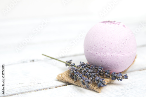 Natural cosmetics. Handmade lavender bath bombs and lavender flowers on white wooden planks