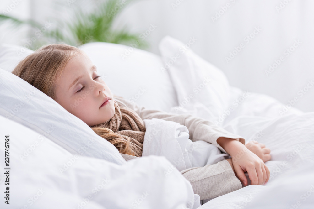 sick child with scarf over neck sleeping in bed at home sick child with scarf over neck sleeping in bed at home
