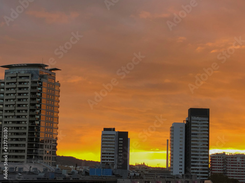 views of a cityscape at an autumn sunset