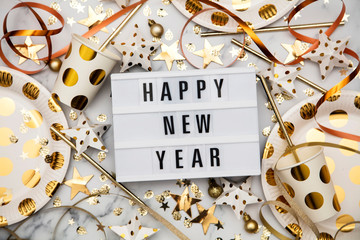 Happy new year lightbox celebration message with luxury gold party decorations