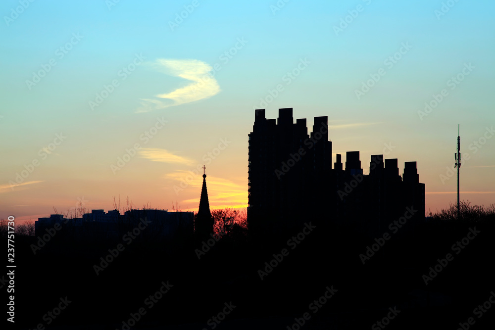 silhouette of building in setting sun