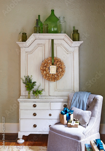 Interior with rustic dresser and armchair