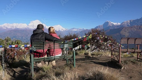Romantic Couple Enjoying the View of the Himalayas. Two Young People Hike Together in Nepal. Active Tourism in the Mountains photo